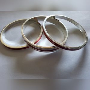 Red and white metal bangel bracelets.